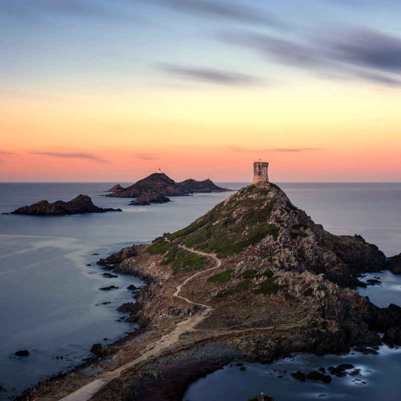 Sunrise over the Genoese tower and lighthouse at Pointe de la Parata and Les Iles Sanguinaires near Ajaccio in Corsica